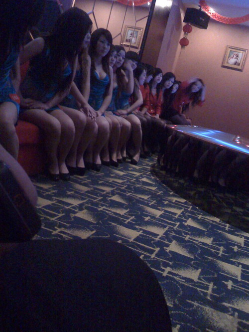 a group of girls sitting in the hall waiting for clients to pick ups